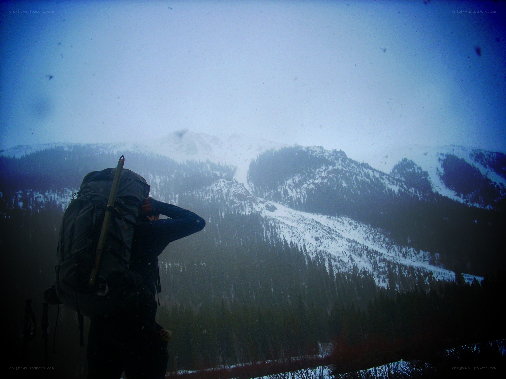 Hiker views snowy mountains