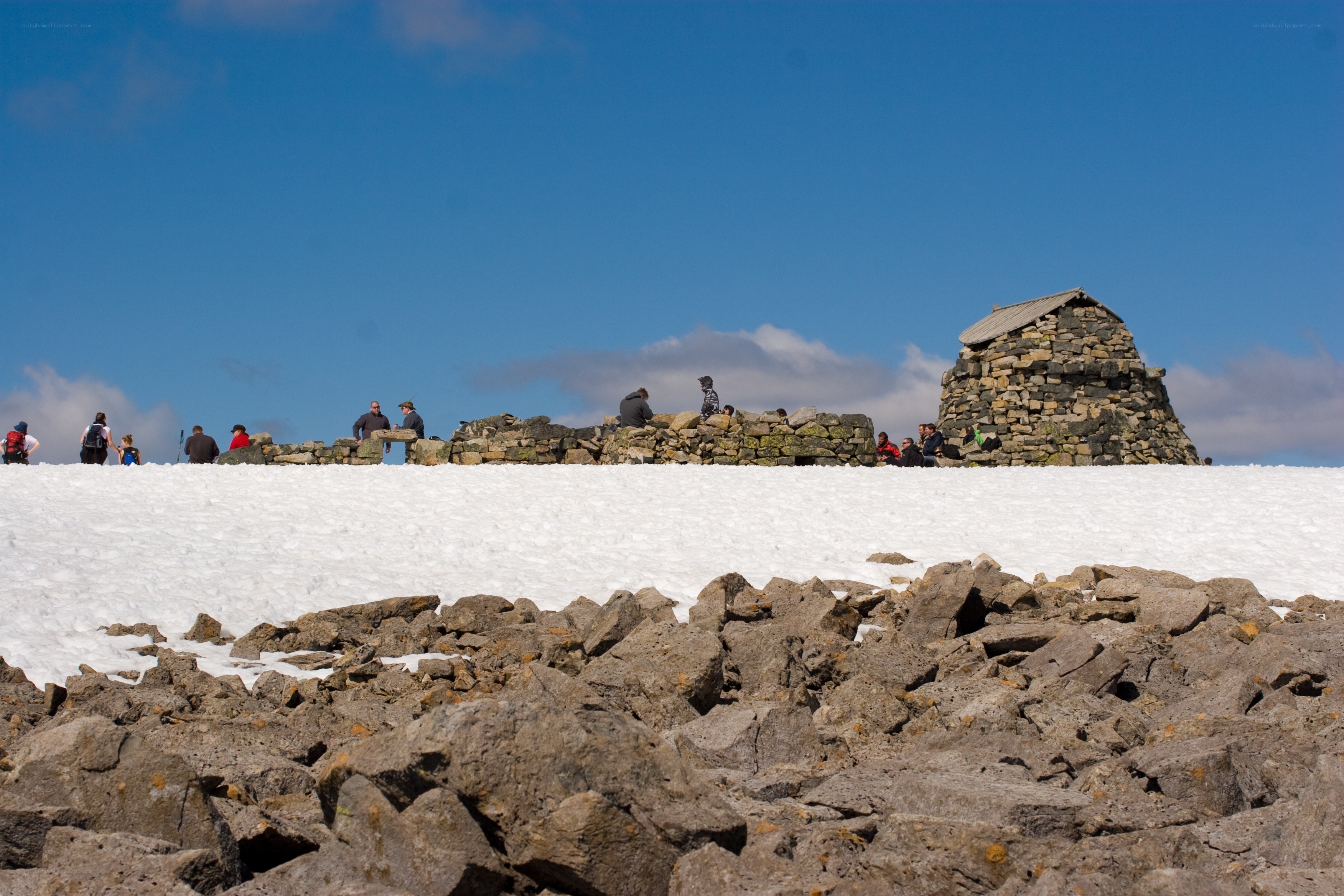Hikers at a snowy mountain summit