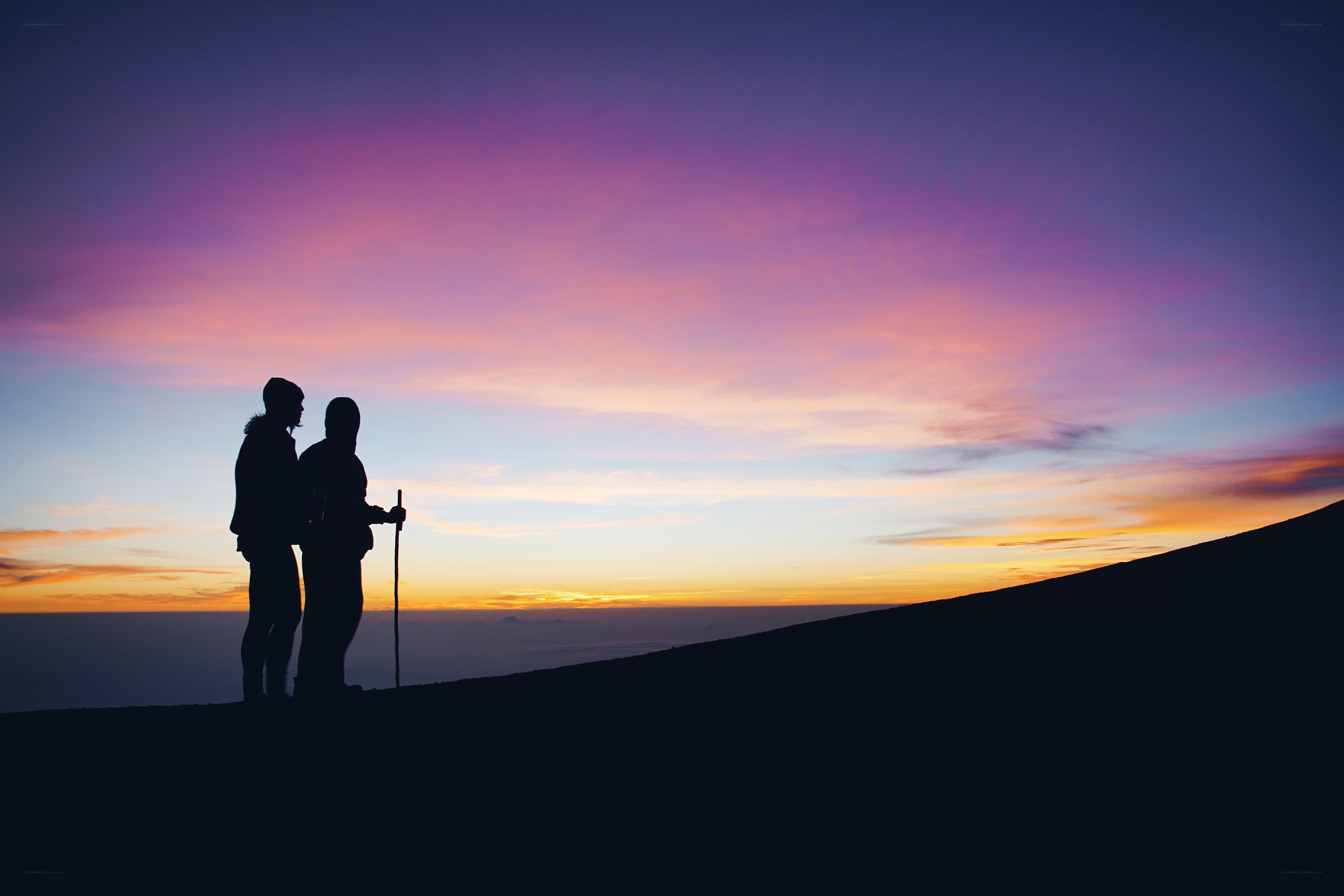 Hikers at sunset on a mountain