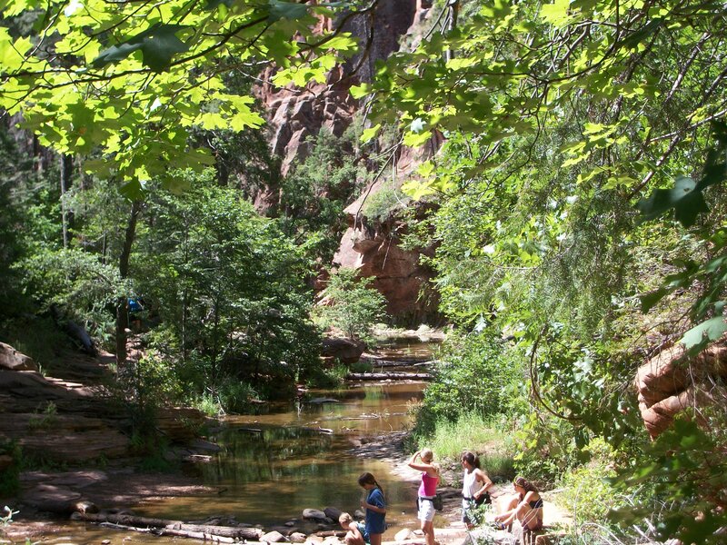 Hikers by a Stream