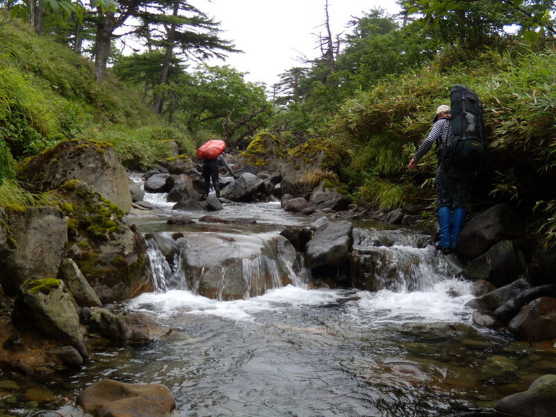 Hikers Crossing Stream