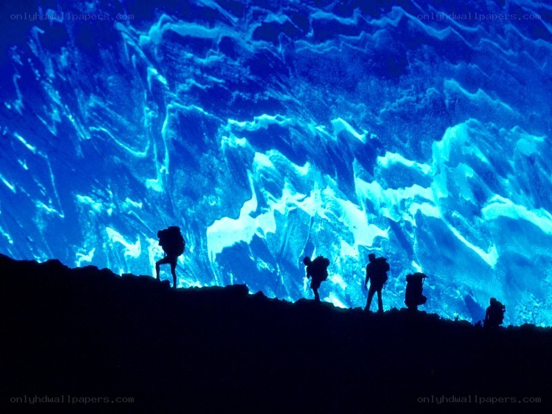 hikers in a blue cave
