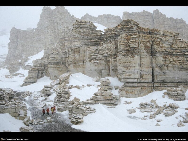 Hikers in snowy mountain canyon