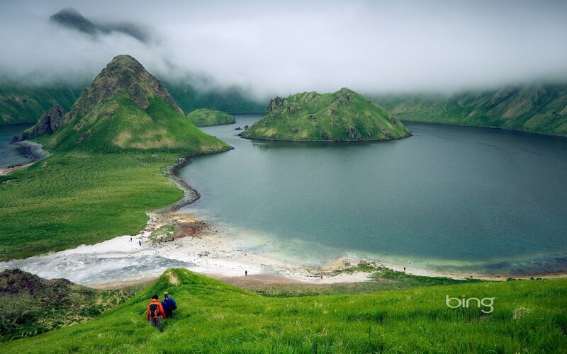 Hikers near a misty lake