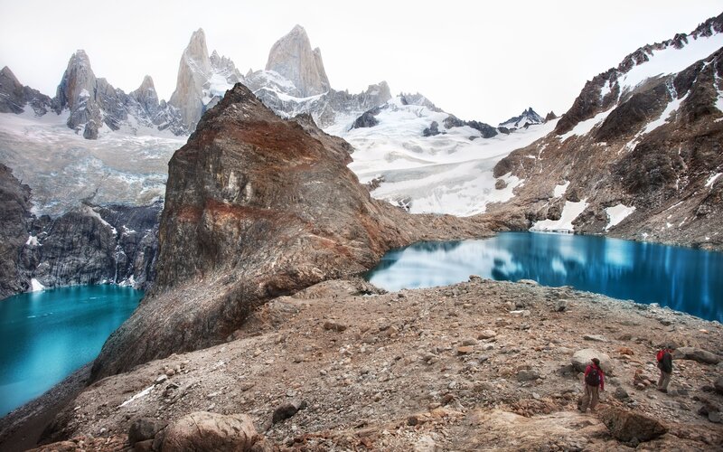 Hikers near a turquoise lake