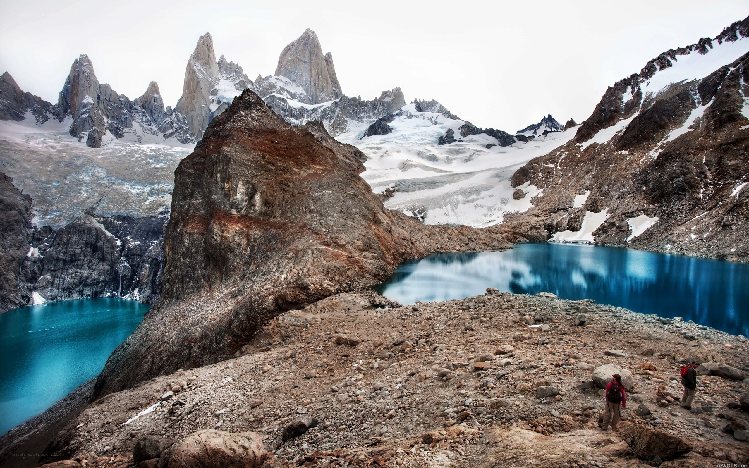 Hikers near a turquoise lake