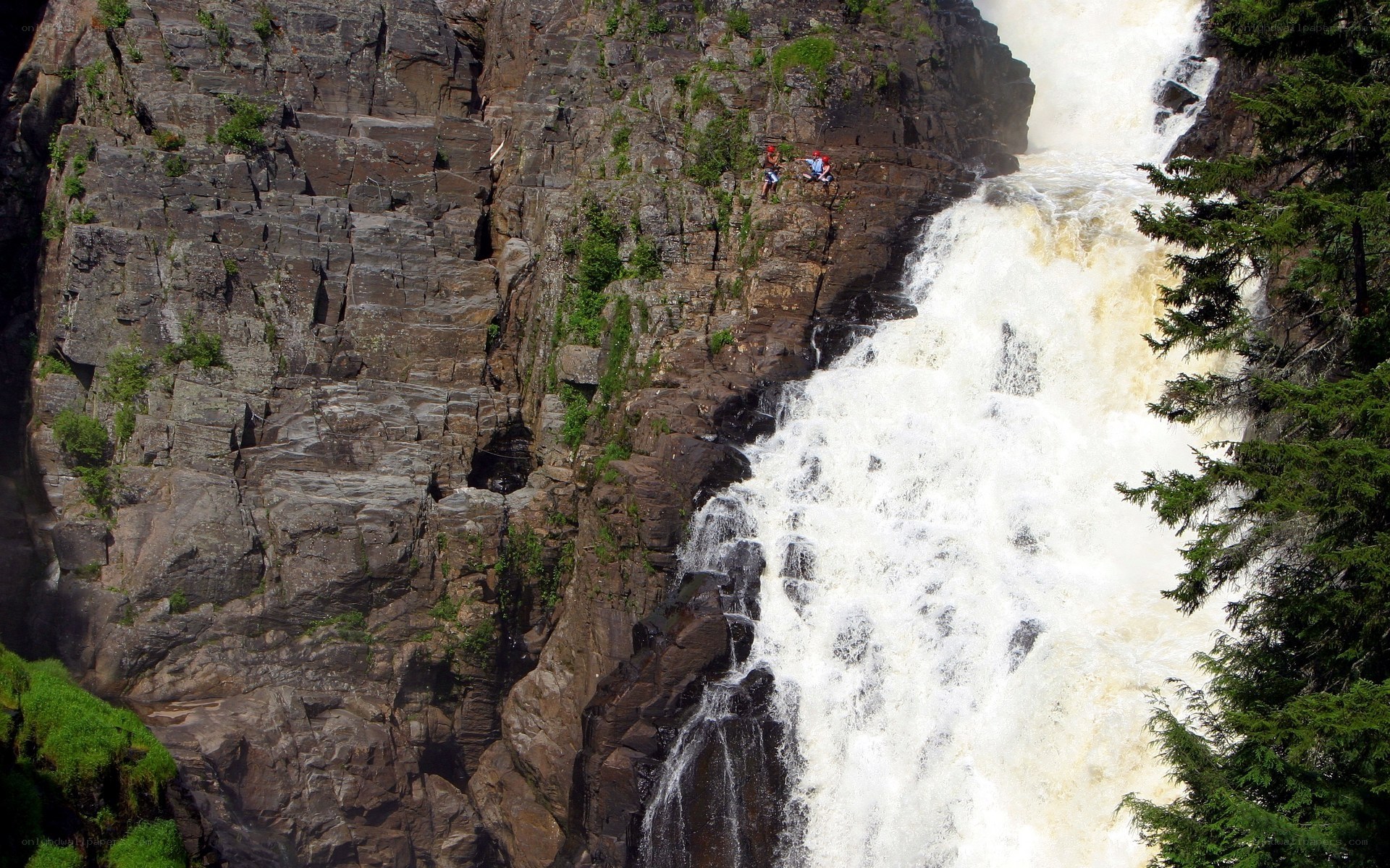 Hikers near a waterfall