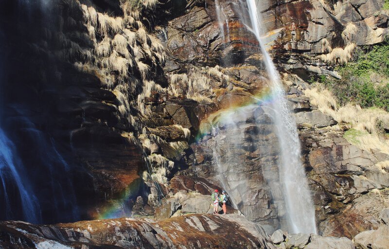Hikers Near Waterfall