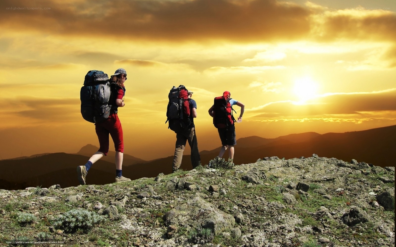Hikers on a mountain at sunset