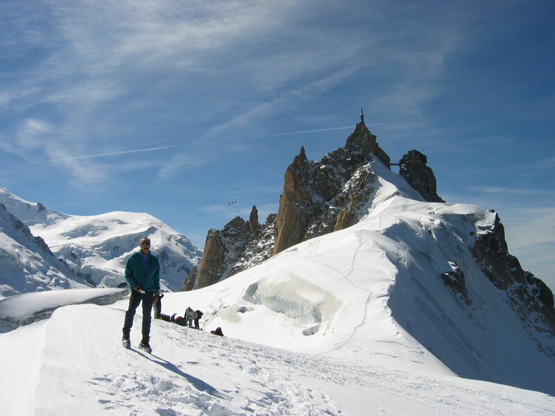 Hikers on a snowy mountain peak