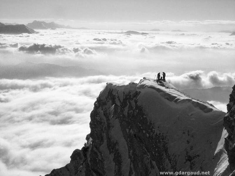 Hikers on a snowy mountain peak