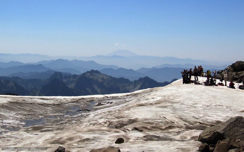 Hikers on a snowy mountain peak