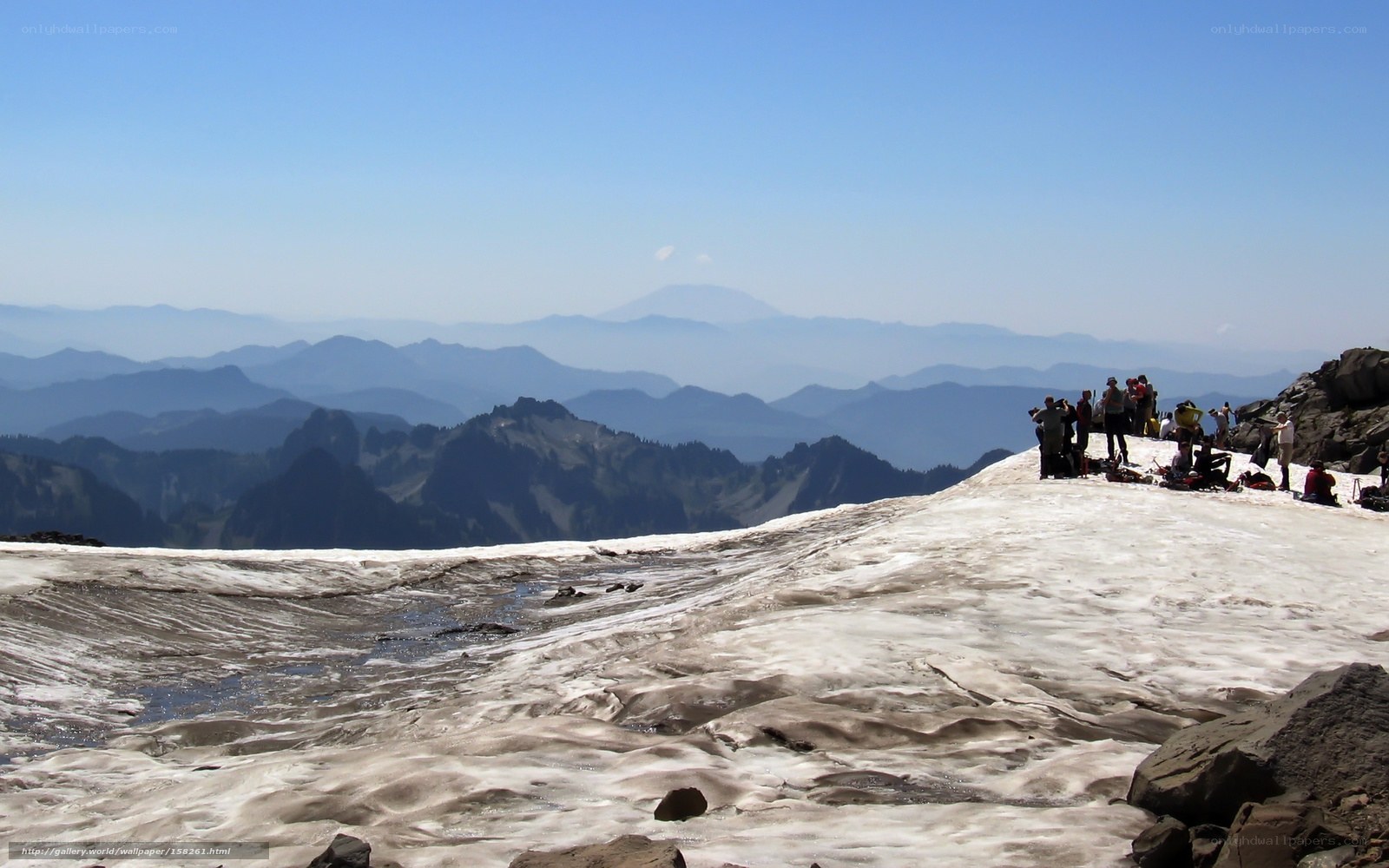 Hikers on a snowy mountain peak