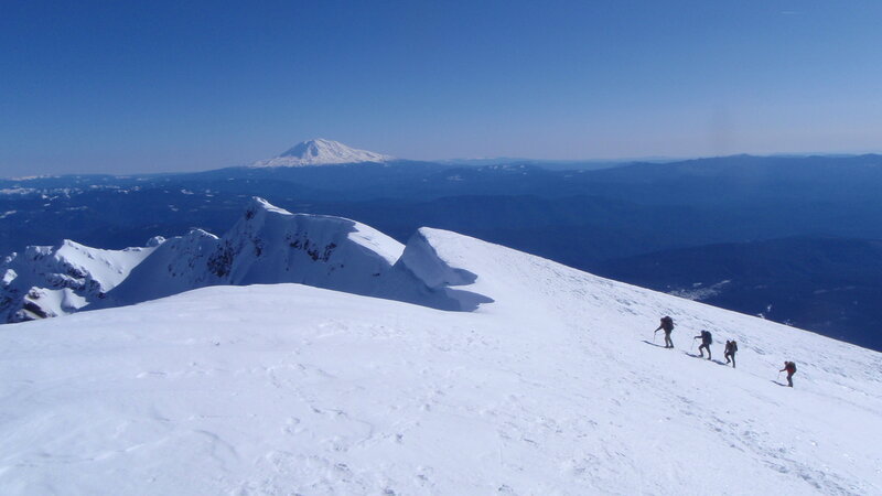 Hikers on a snowy mountain ridge