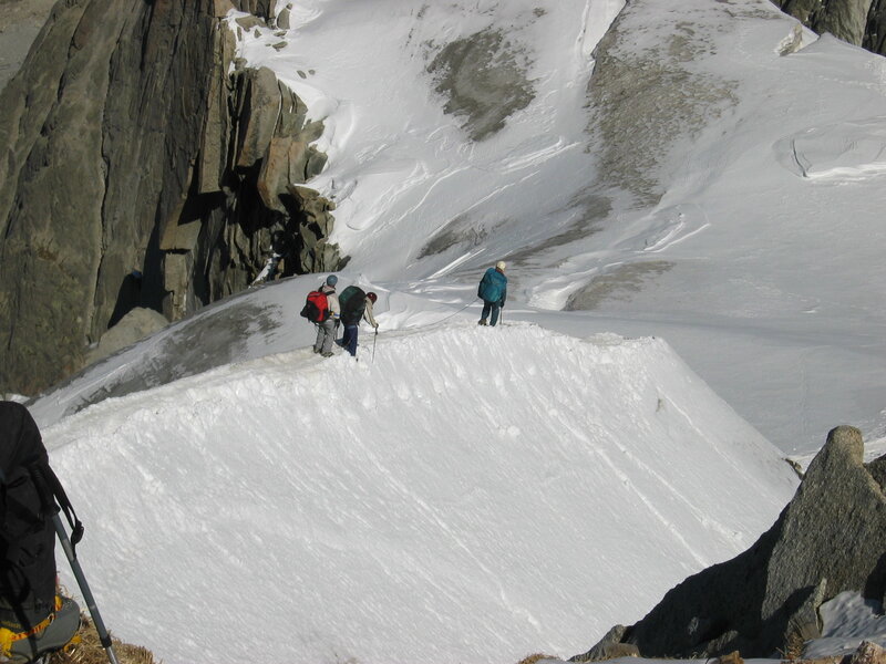 Hikers on a snowy mountain ridge