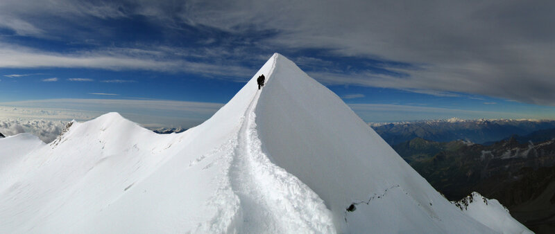 Hikers on a snowy mountain ridge