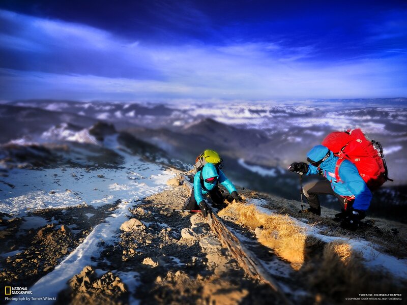 Hikers on a snowy mountain ridge