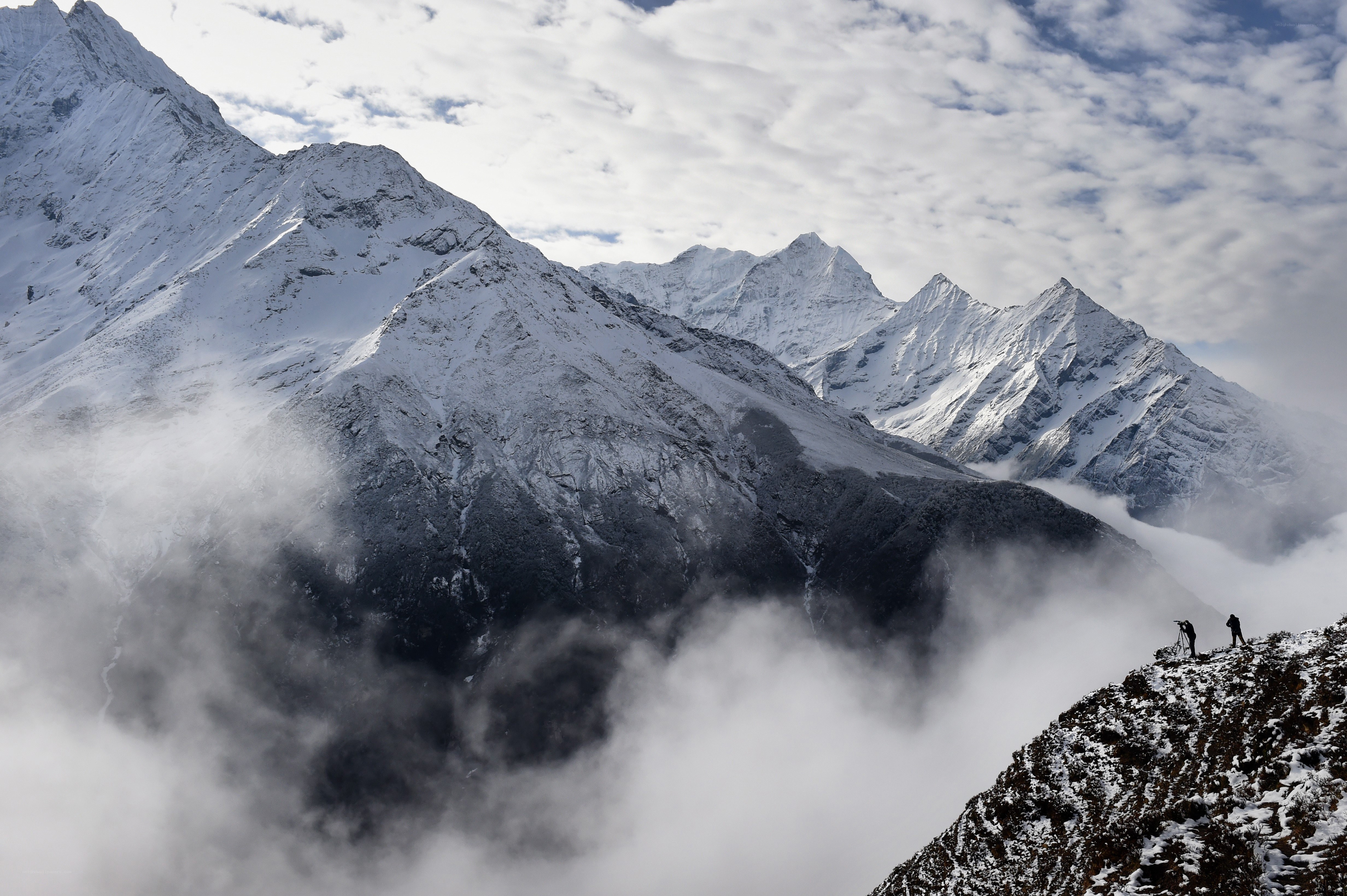Hikers on a snowy mountain ridge