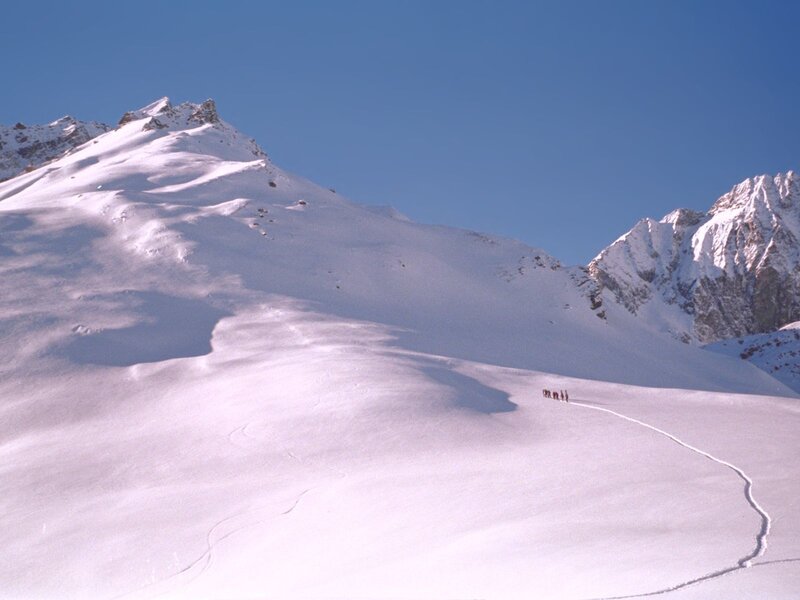 Hikers on a snowy mountain slope