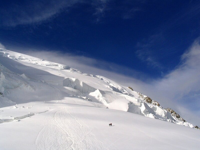 Hikers on a snowy mountain slope