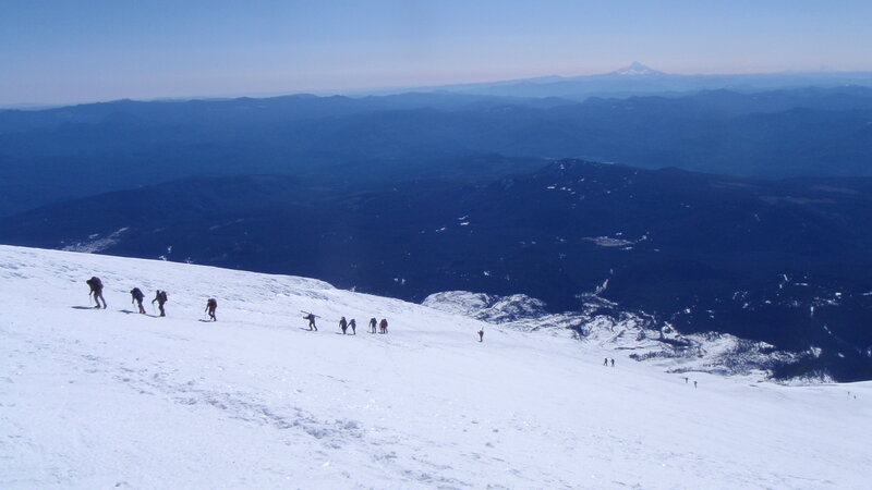 Hikers on a snowy mountain slope