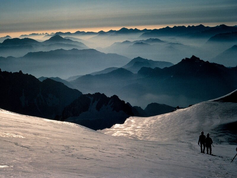 Hikers on a snowy mountain slope