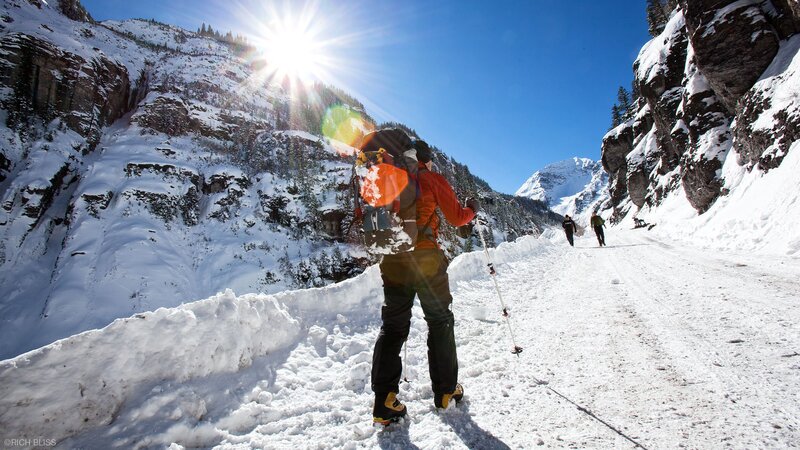 Hikers on a snowy mountain trail