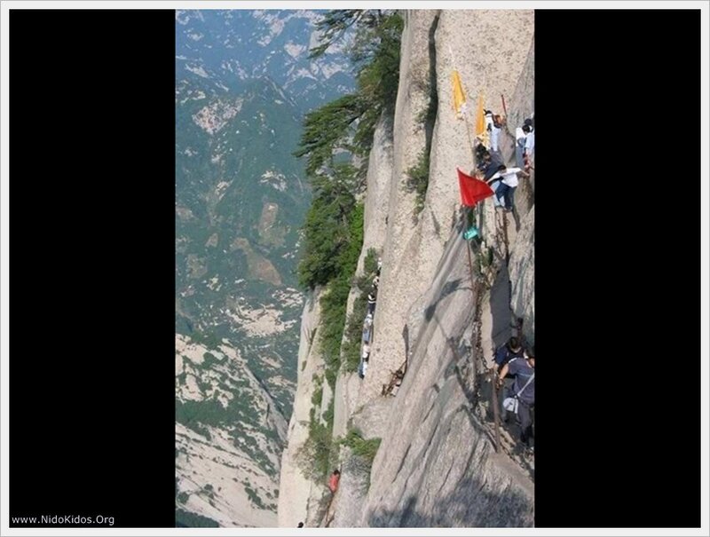 Hikers on a steep mountain path
