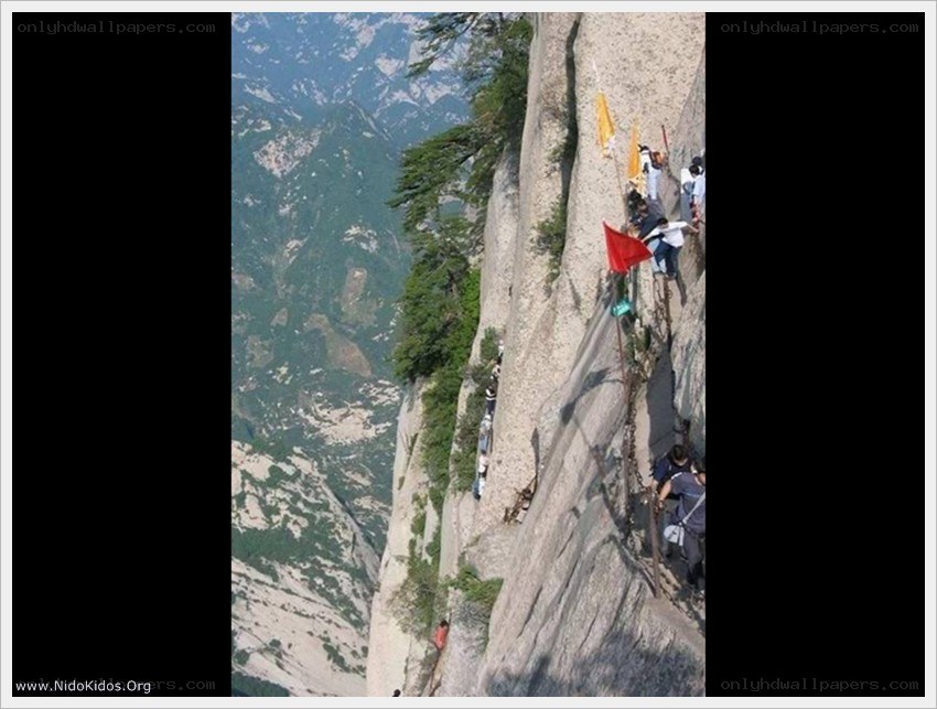 Hikers on a steep mountain path