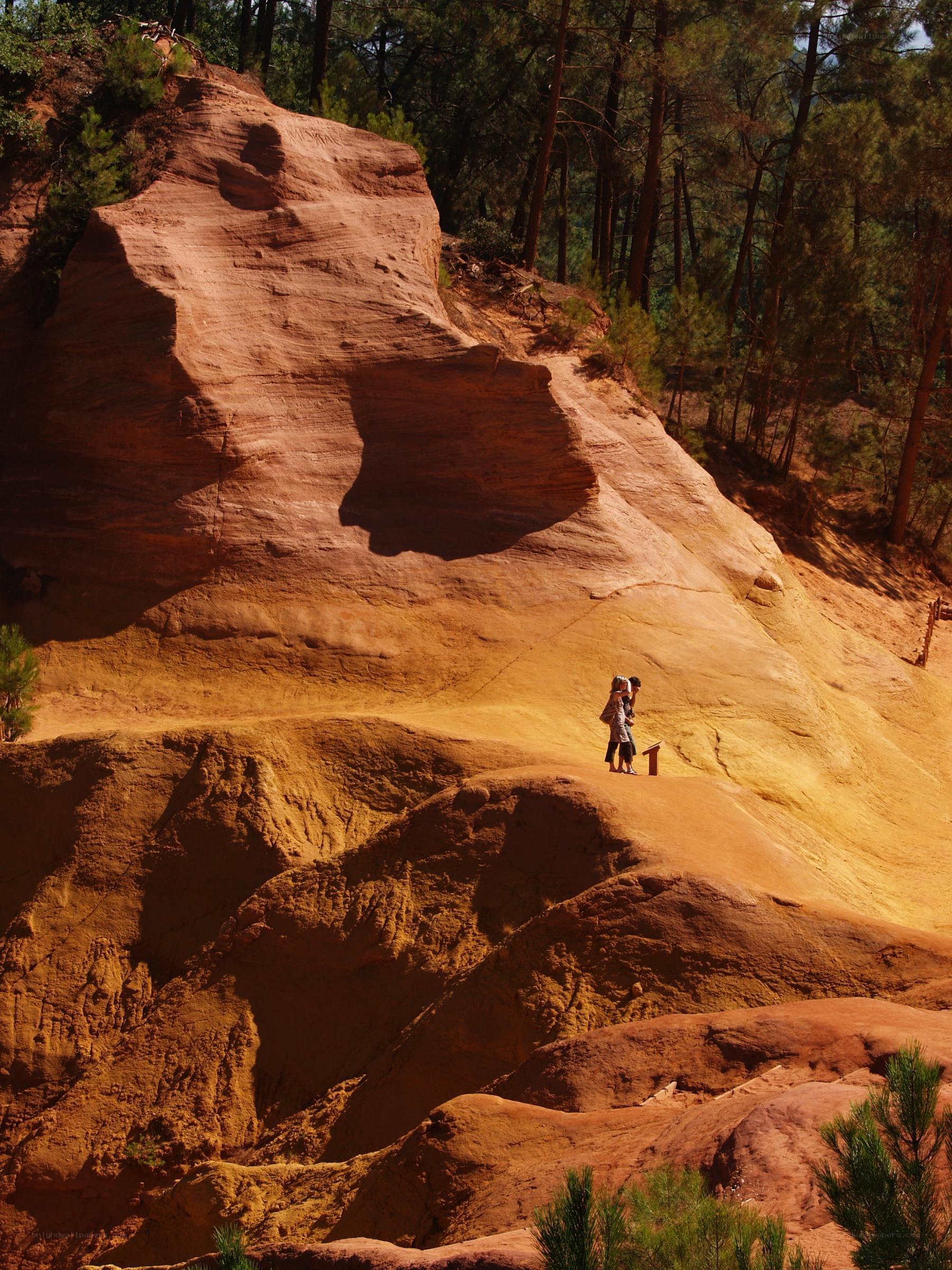 Hikers on red rock formation