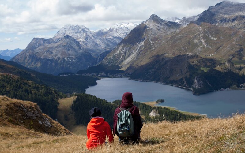 Hikers overlook mountain lake