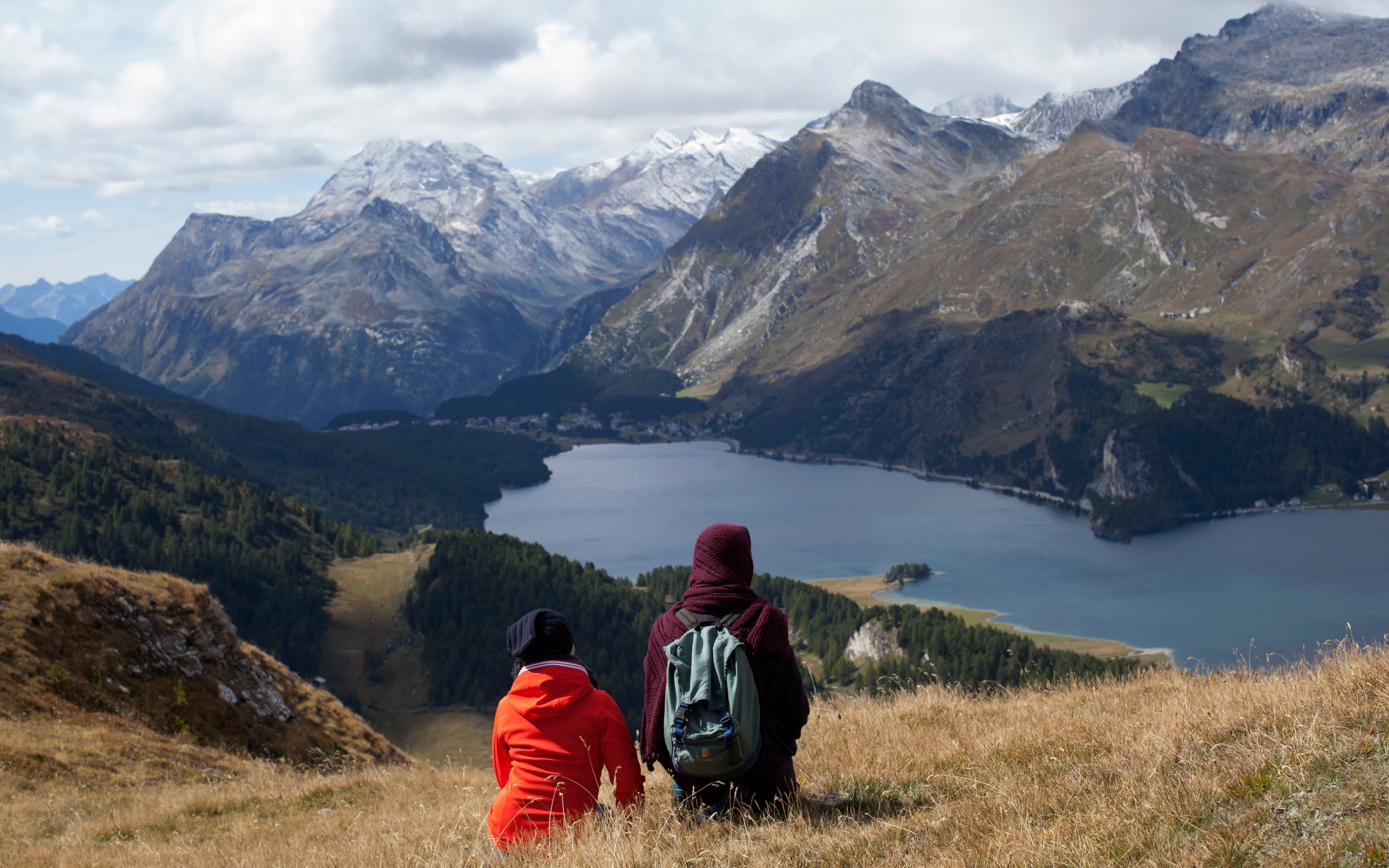 Hikers overlook mountain lake