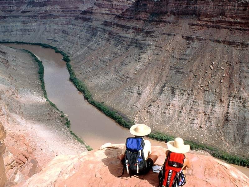 Hikers overlooking a river canyon
