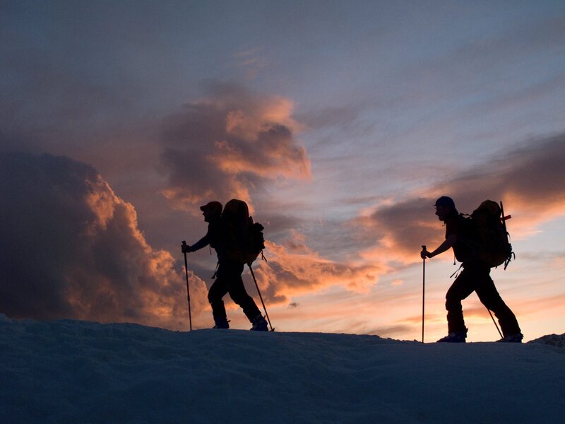 Hikers silhouetted at sunset