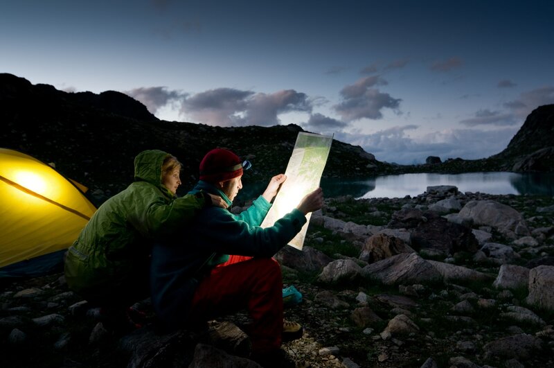 Hikers study map at campsite
