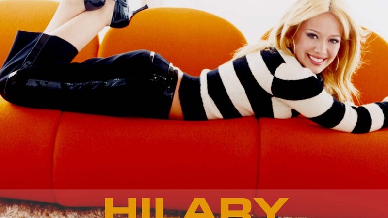 Hilary Duff on a red couch