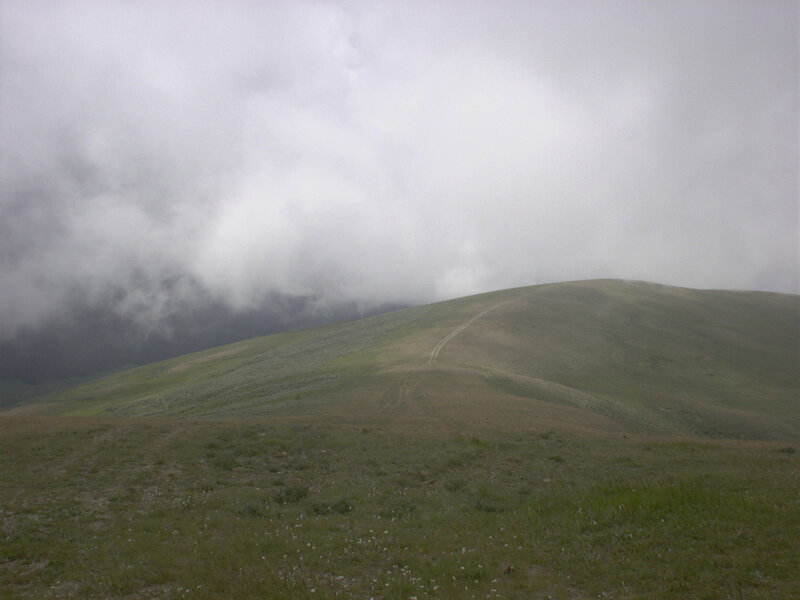 Hill under cloudy sky