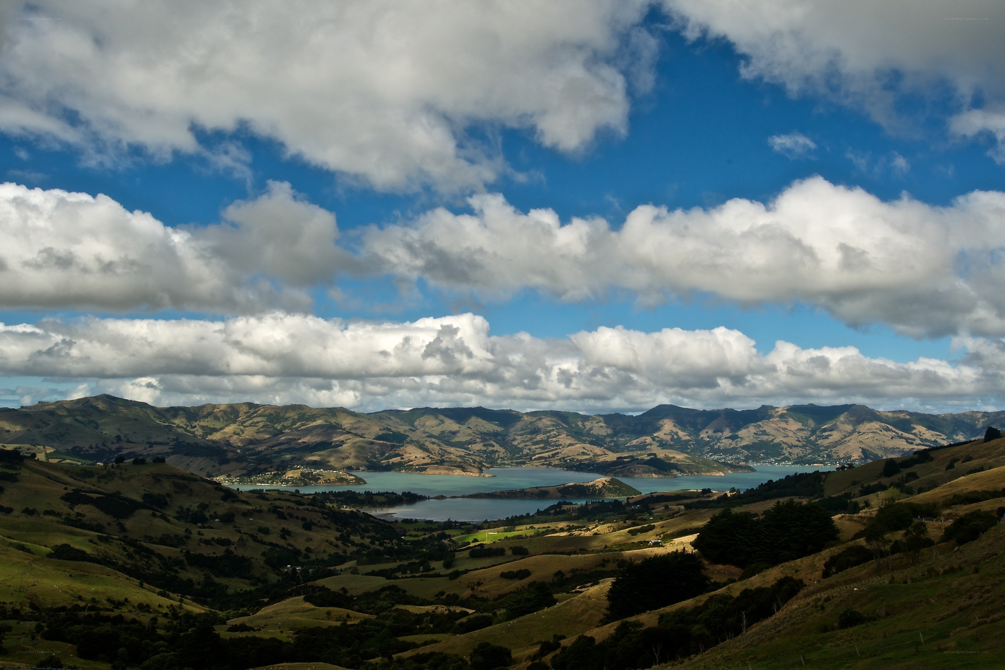 Hills and bay under cloudy sky