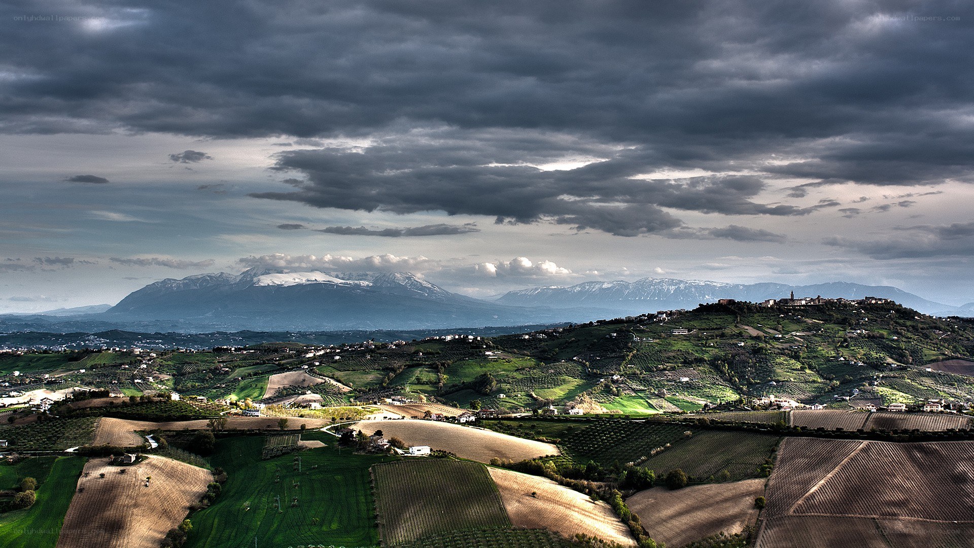 Hills and mountains under stormy sky