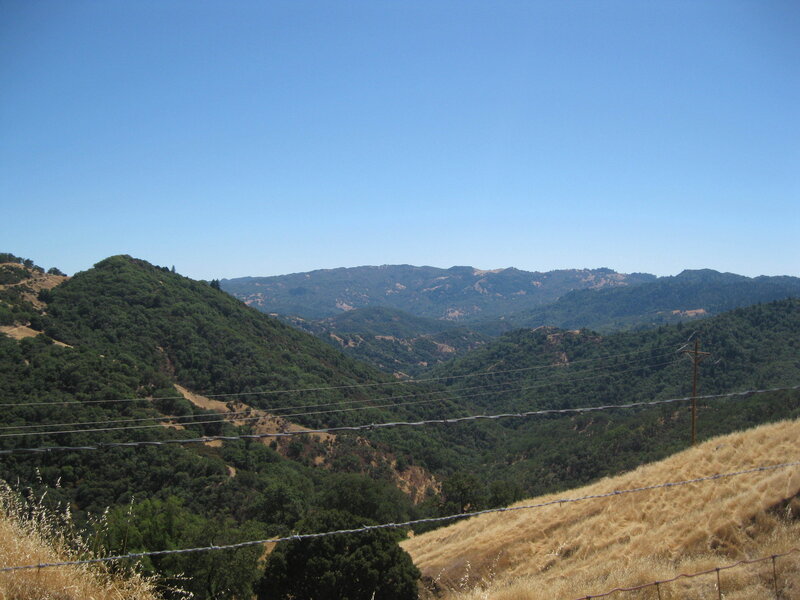 hills and valleys under blue sky