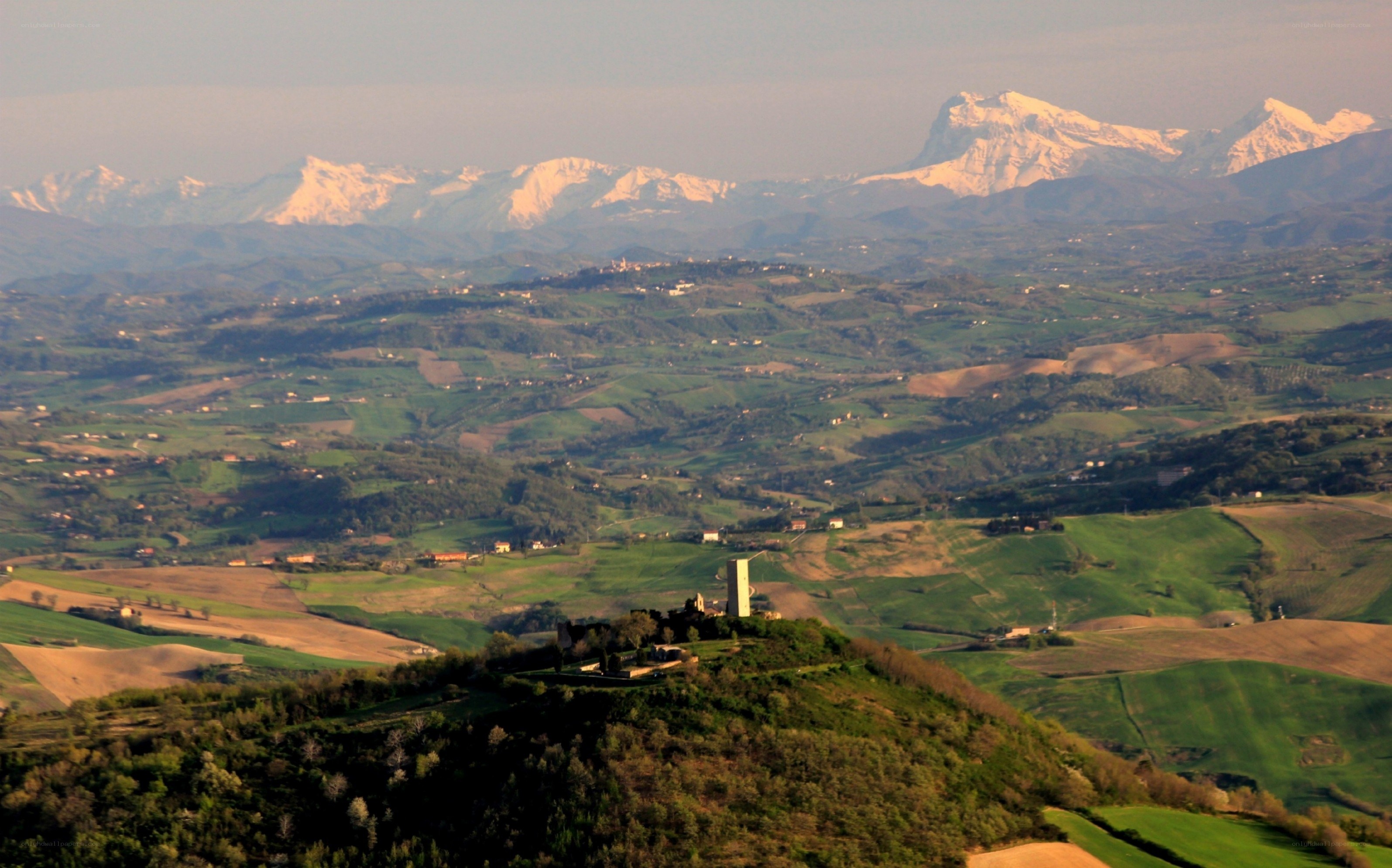 hills with snow-capped mountains