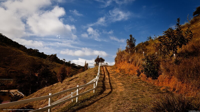 Hillside path with white fence