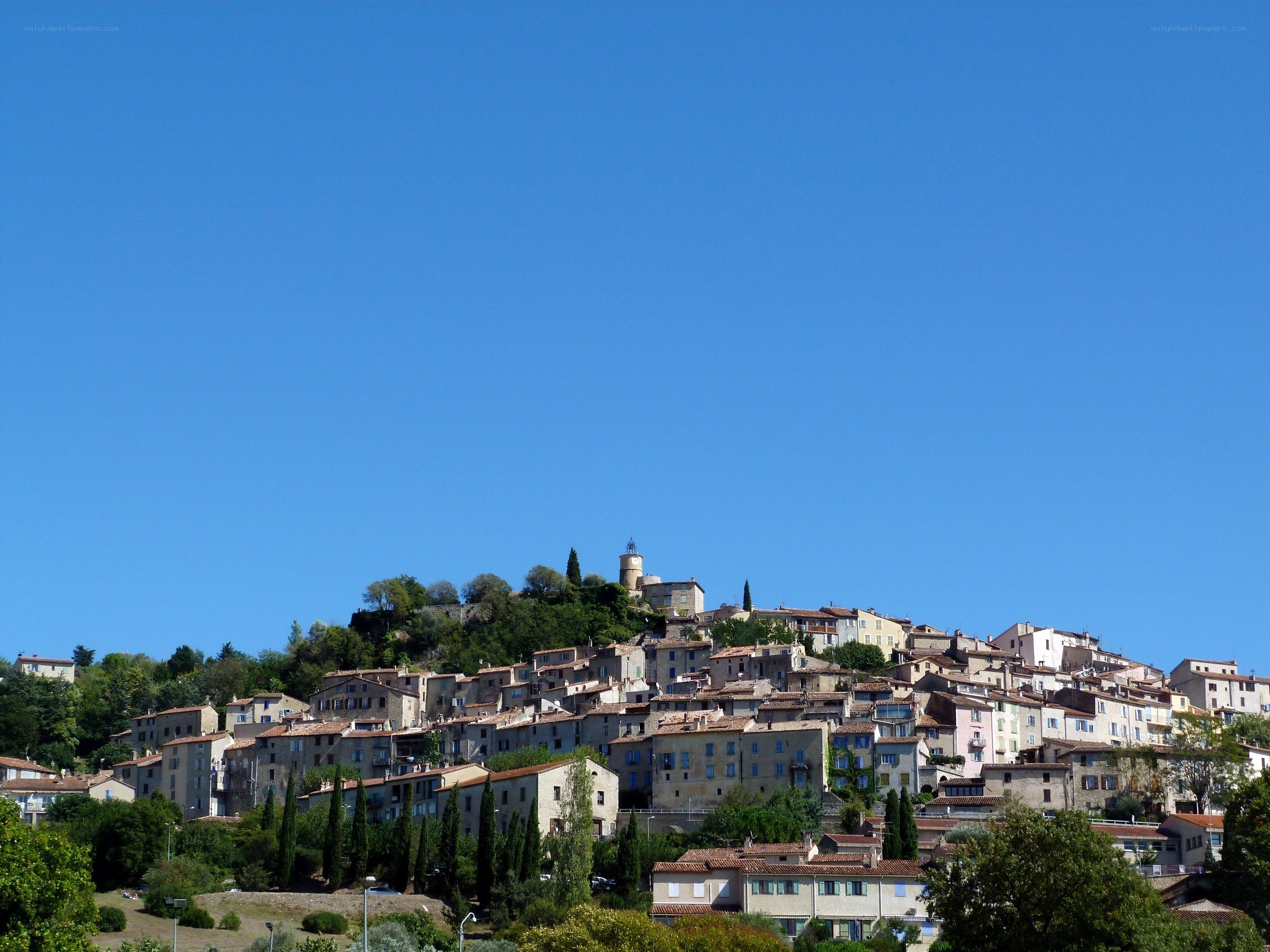 Hillside village under clear blue sky