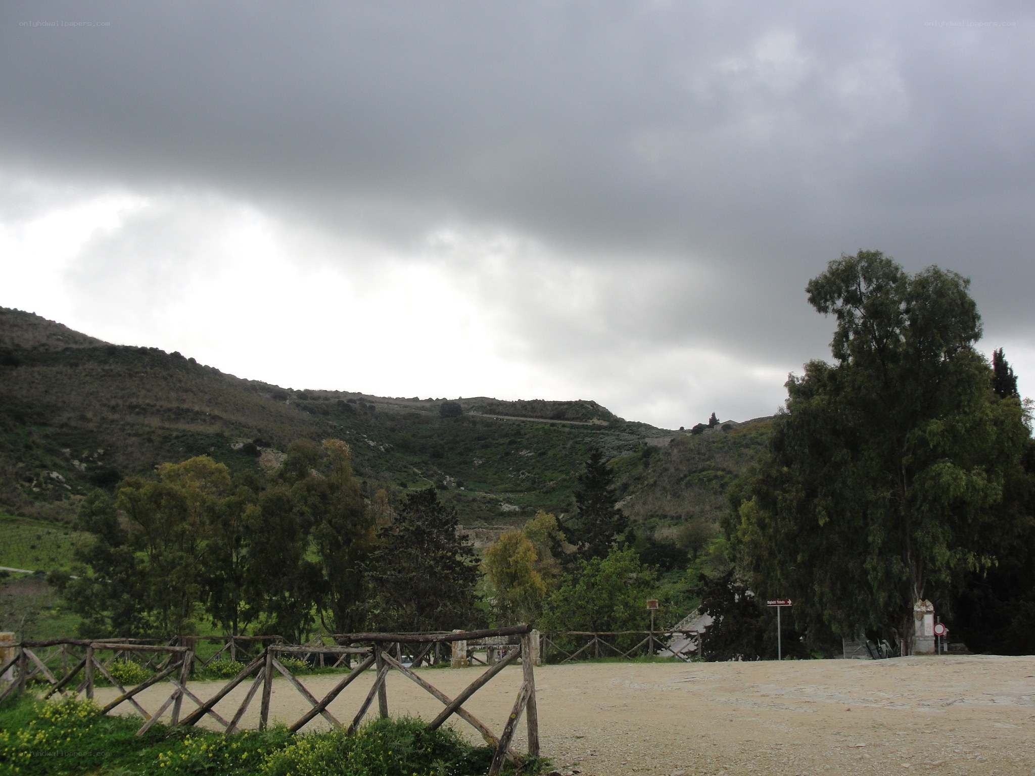 Hilly landscape under cloudy sky