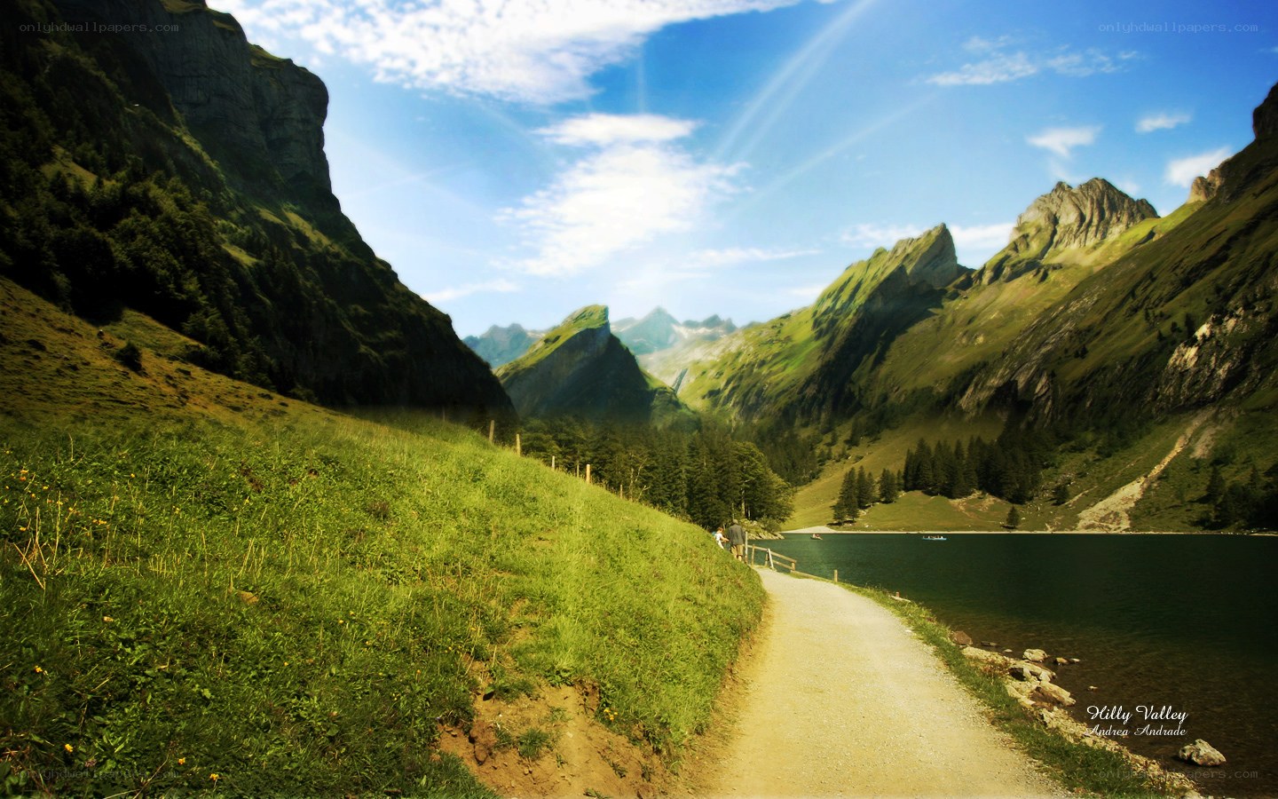 Hilly valley with lake and path