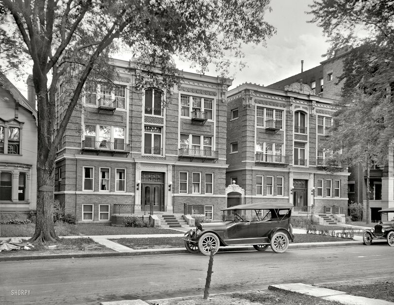 Historic apartment buildings and vintage cars