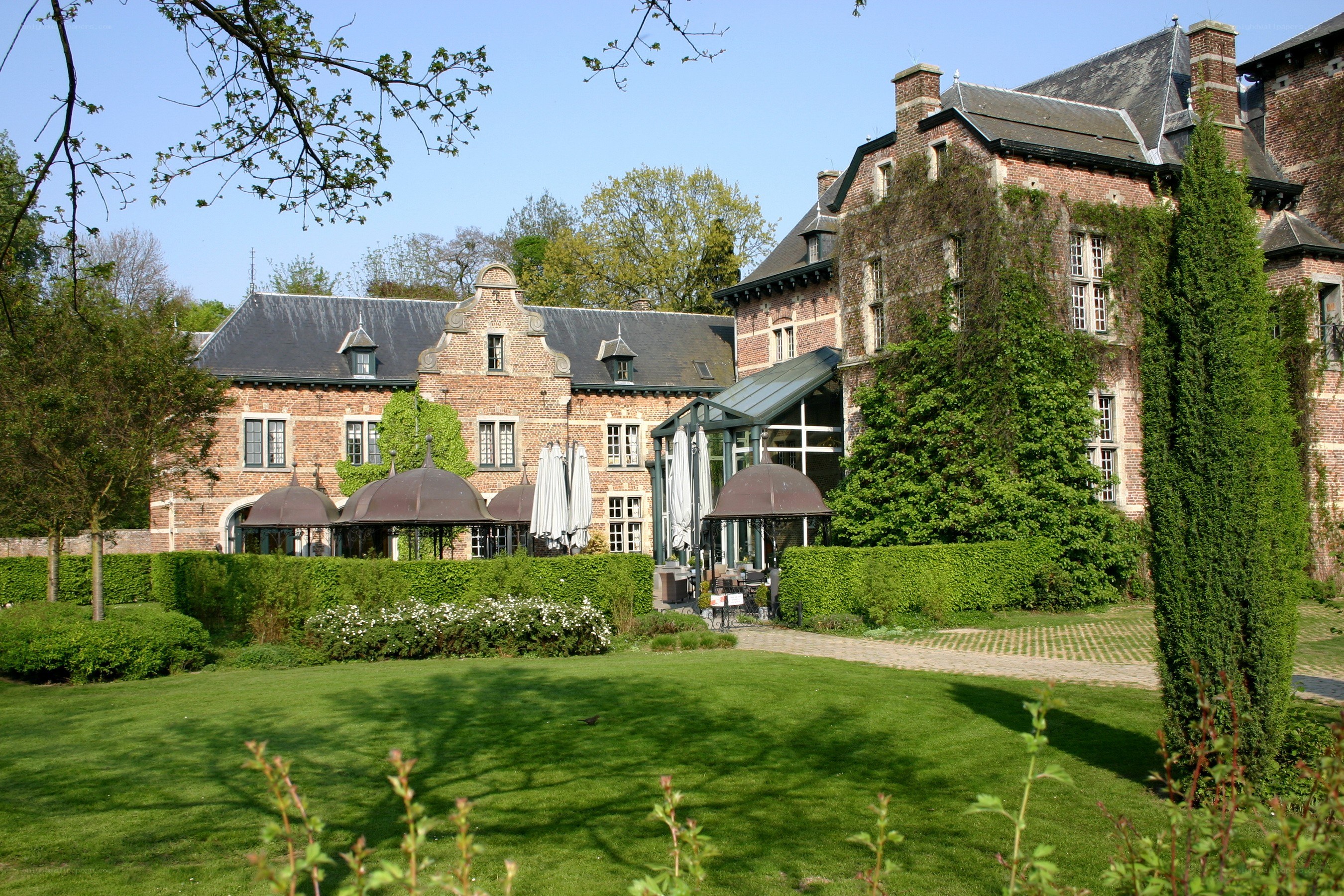 historic brick building with gardens