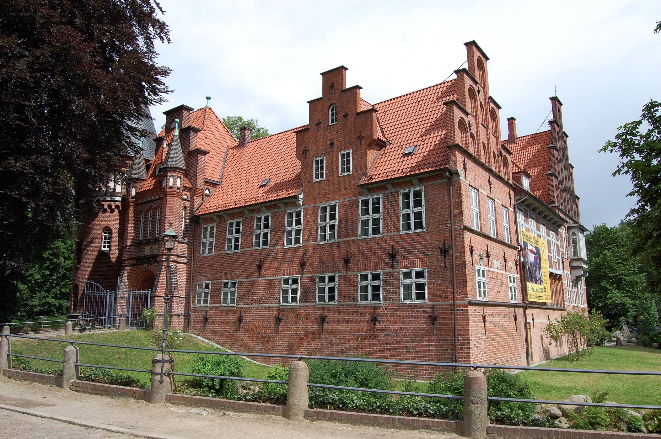 historic brick building with red roof