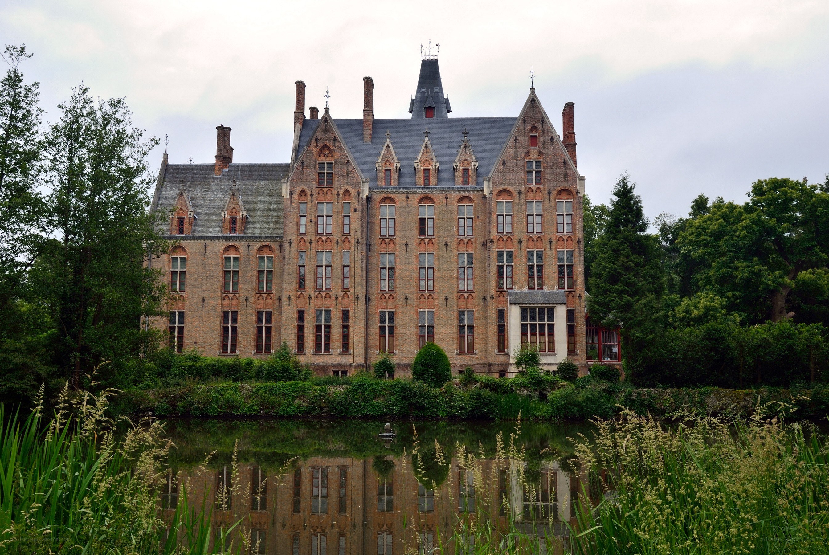 Historic brick castle by a pond