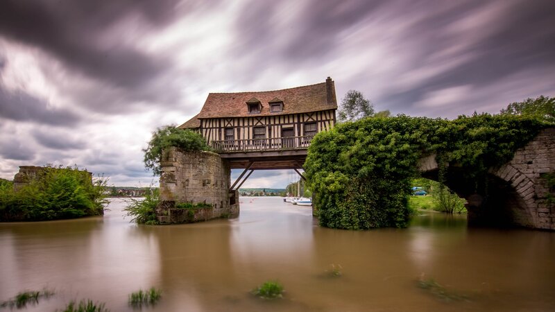 Historic bridge with house over river